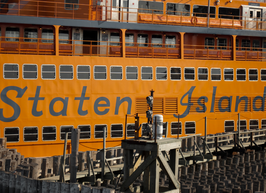 The Staten Island Ferry with yellow background and black lettering of the ferry.