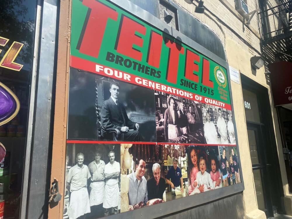 A sign at Tietel Brothers in "The Real Little Italy" detailing their four generations of existence.