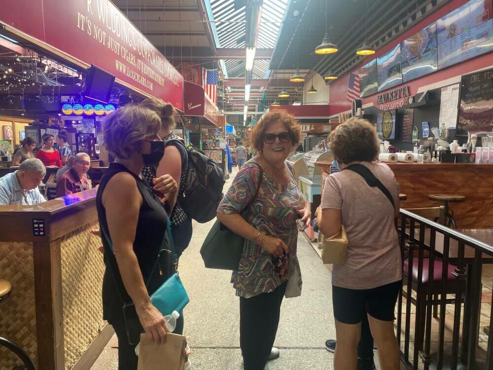 Two women with SusanSez during a walking tour of Arthur Avenue Market, "The Real Little Italy"