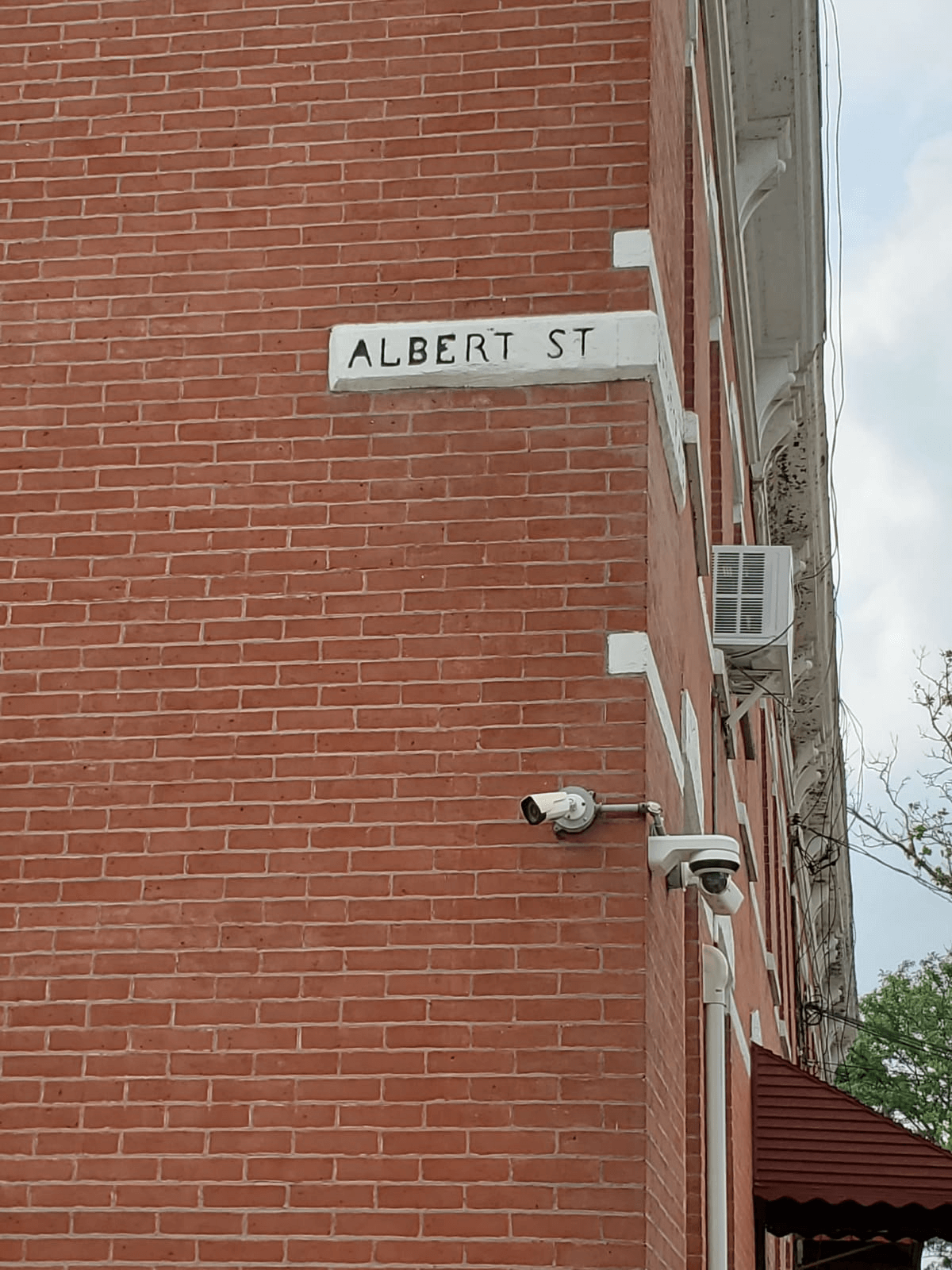 A red brick building with a sign that says "Albert Street"